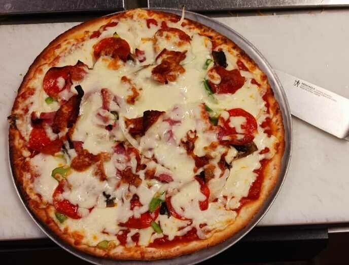 Pepperoni bacon and pepper pizza fresh out of the oven