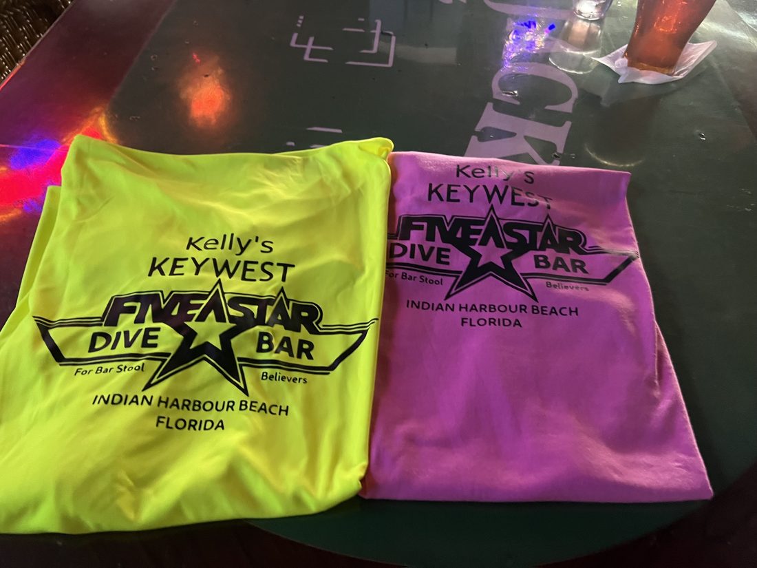 Real Kelly's Keywest tees in neon yellow and pink on the bar